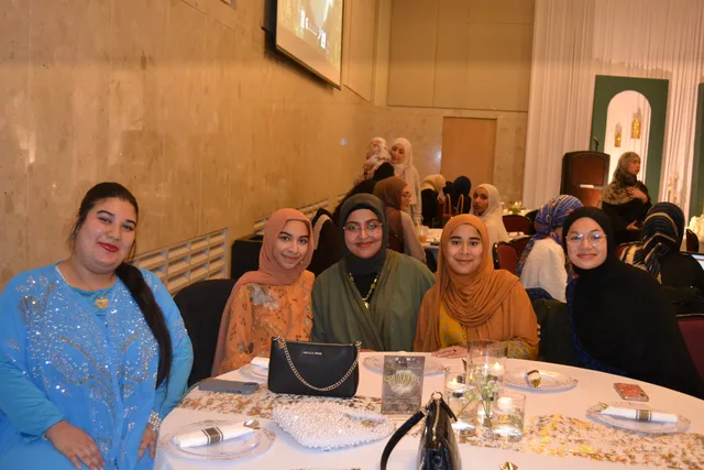 Five attendees seated together
