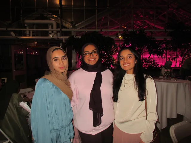 Three attendees together in a greenhouse