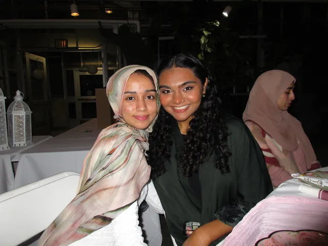 Two attendees posing among greenhouse plants