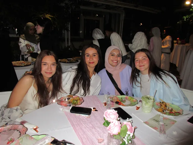 Four attendees sharing a table in the greenhouse