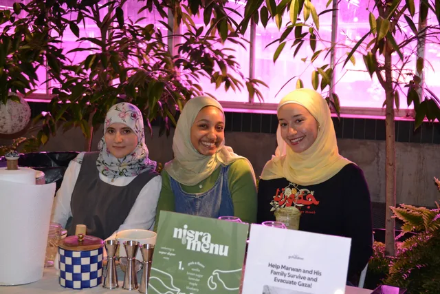 Three volunteers behind the matcha table