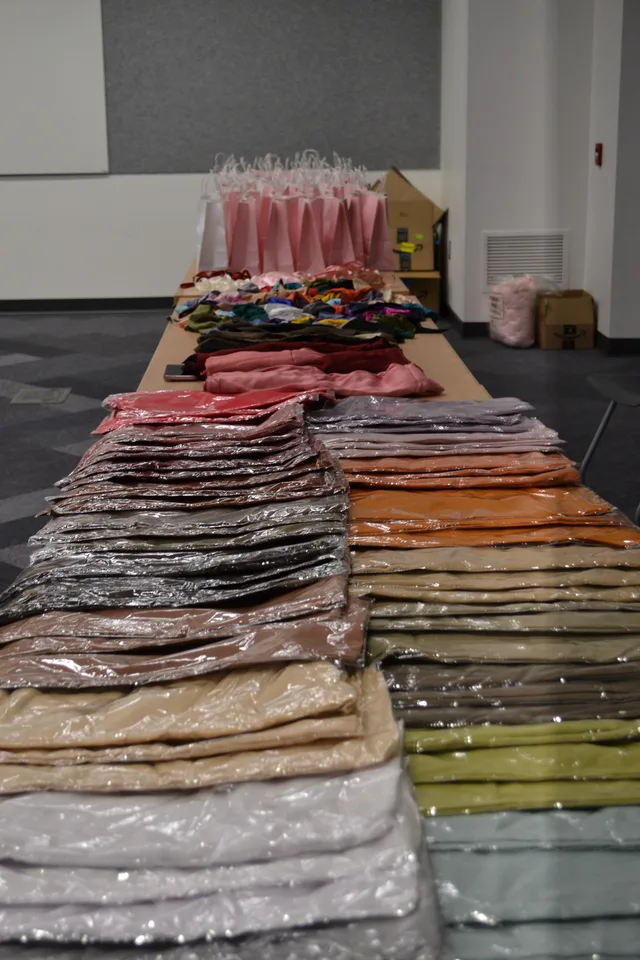 Colorful hijabs and gift bags arranged on tables