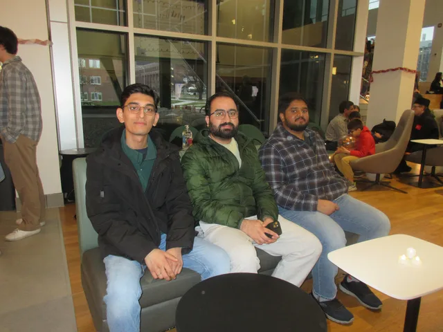 Three attendees seated together on a sofa