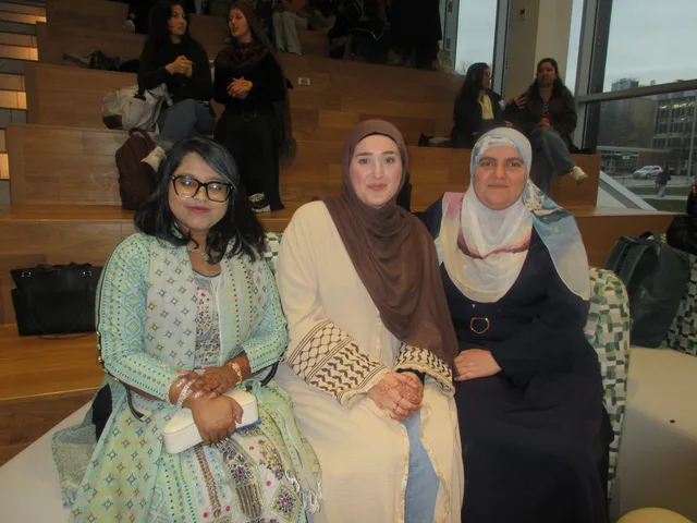 Three guests seated in front of wooden steps