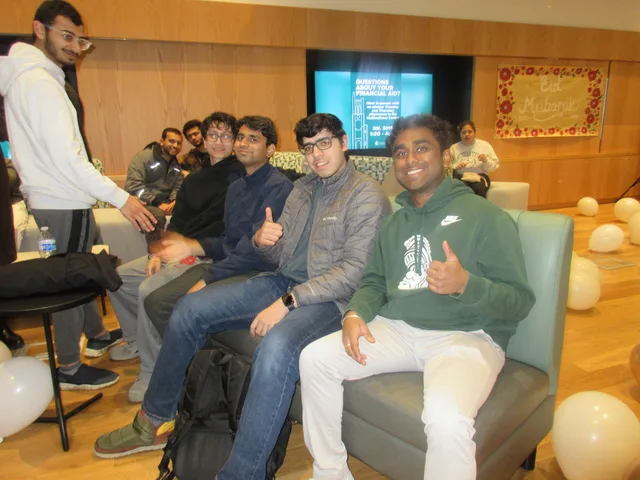 Attendees smiling from a sofa at a celebration