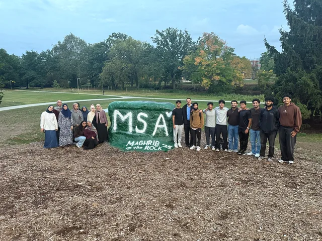MSA students standing beside the Rock painted green with MSA lettering